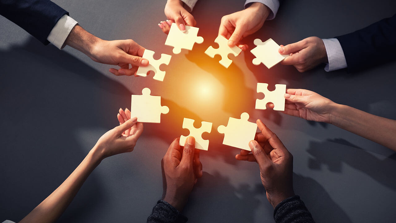 Abstract business people holding puzzle pieces Abstract business people holding puzzle pieces