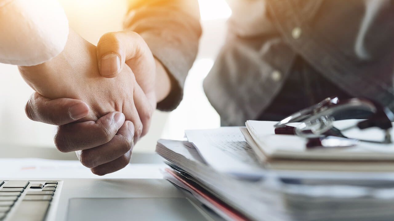 Close up of two people shaking hands Close up of two people shaking hands