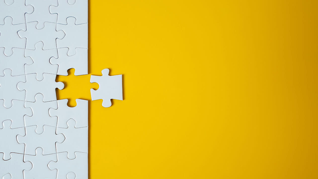 White puzzle pieces on solid yellow background White puzzle pieces on solid yellow background